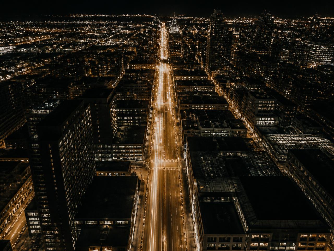 Aerial view of a city avenue with golden light trails